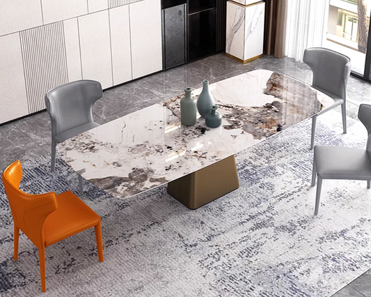 Modern dining room with a marble table and gray chairs, one orange chair.
